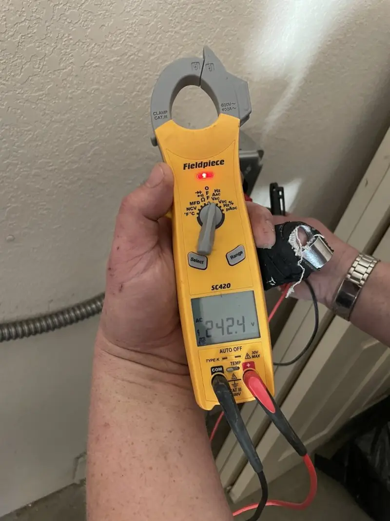Voltage testing with clamp meter during Outlet Installation in Haworth
